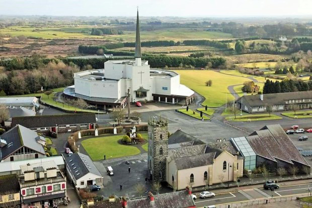Modern Basilica in back, original church in front, the chapel shrine attachment is on the right side of the old church