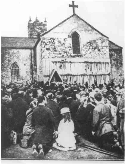 Old photo showing how the wall looked with folks praying at it.