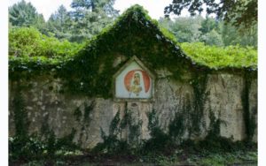 Ivy covered ruins with image of the Madonna holding baby Jesus
