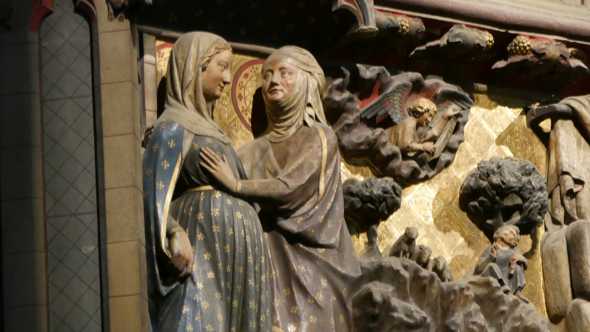 Photo of Close up view of a scene in the Life of the Virgin Mary and I believe she is being greeted by her cousin Elizabeth on one of the 2 giant wooden carvings.