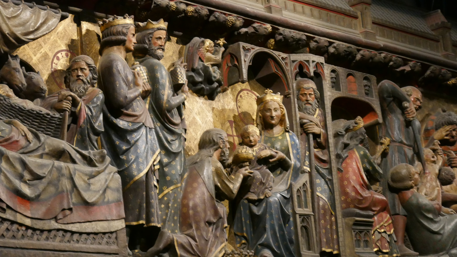 Photo of Close up view of a scene in the Life of the Virgin Mary with the Baby Jesus and the Wise Men paying homage to him on one of the 2 giant wooden carvings.