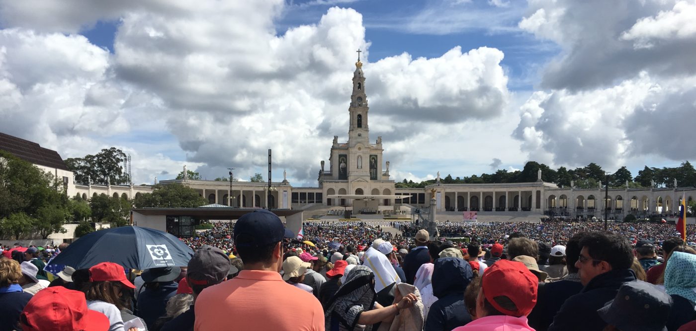 A wider view of the Basilica of Our Lady of the Rosary in Fatima, Portugal. This view includes some of the 1 million people who attended as well as the Colonnades of the Basilica itself. Event date, May 13, 2017.