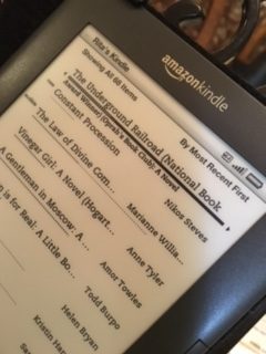 Photo of a Kindle with book's title.