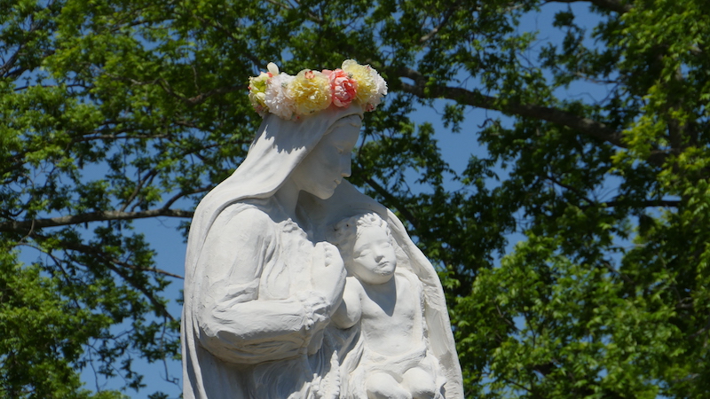 Close up photo of main statue with the wreath of flowers crowning the Virgin Mary