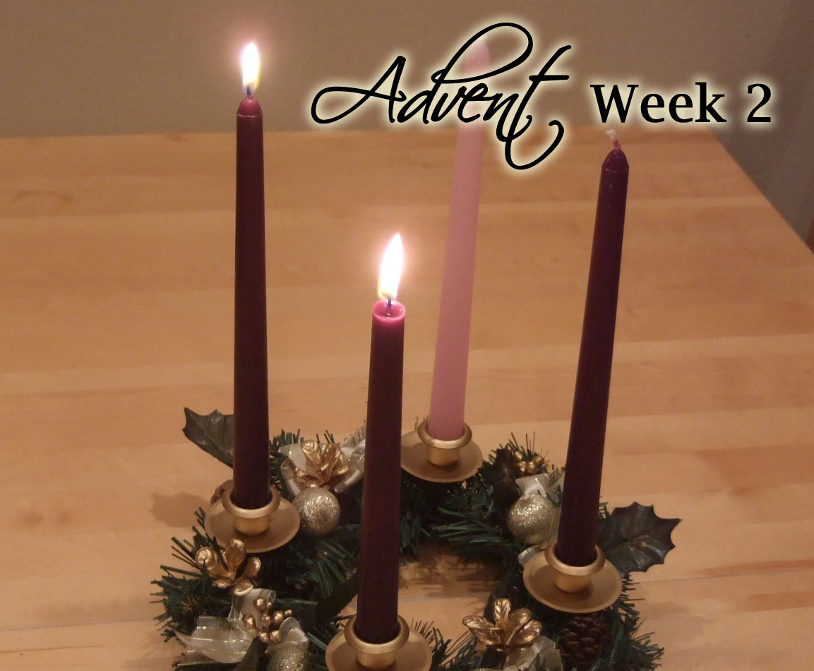 2 candles lit on an Advent wreath