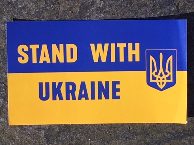 A Blue & Yellow sticker that says, "Stand With Ukraine"