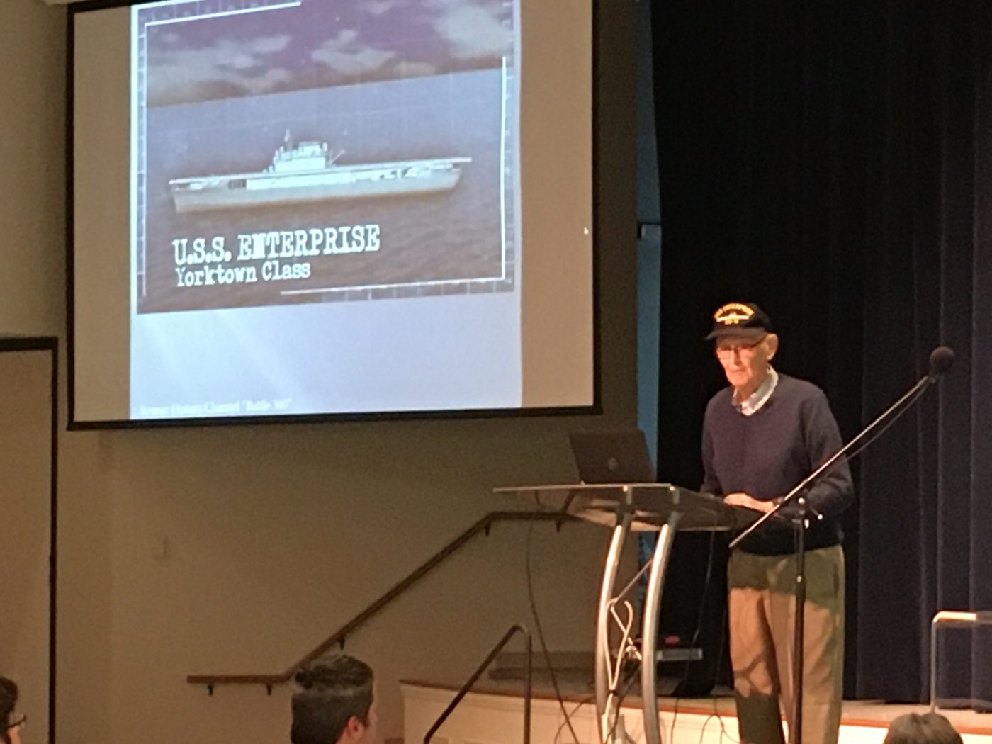 Bill Norberg and a photo of the USS Enterprise.