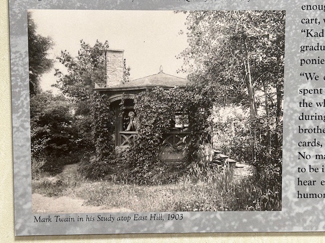Black and White photo of Mark Twain in his study looking out the window in 1903.